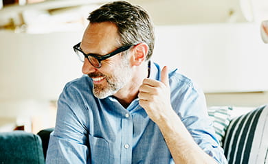 Laughing businessman in meeting with colleagues