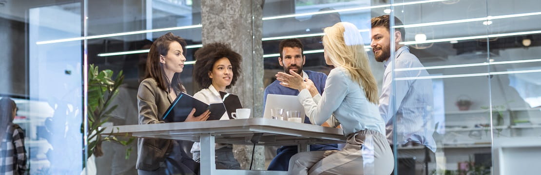 A team of five professionals seated together for a meeting