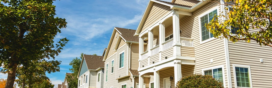 Series of three houses on a sunny day
